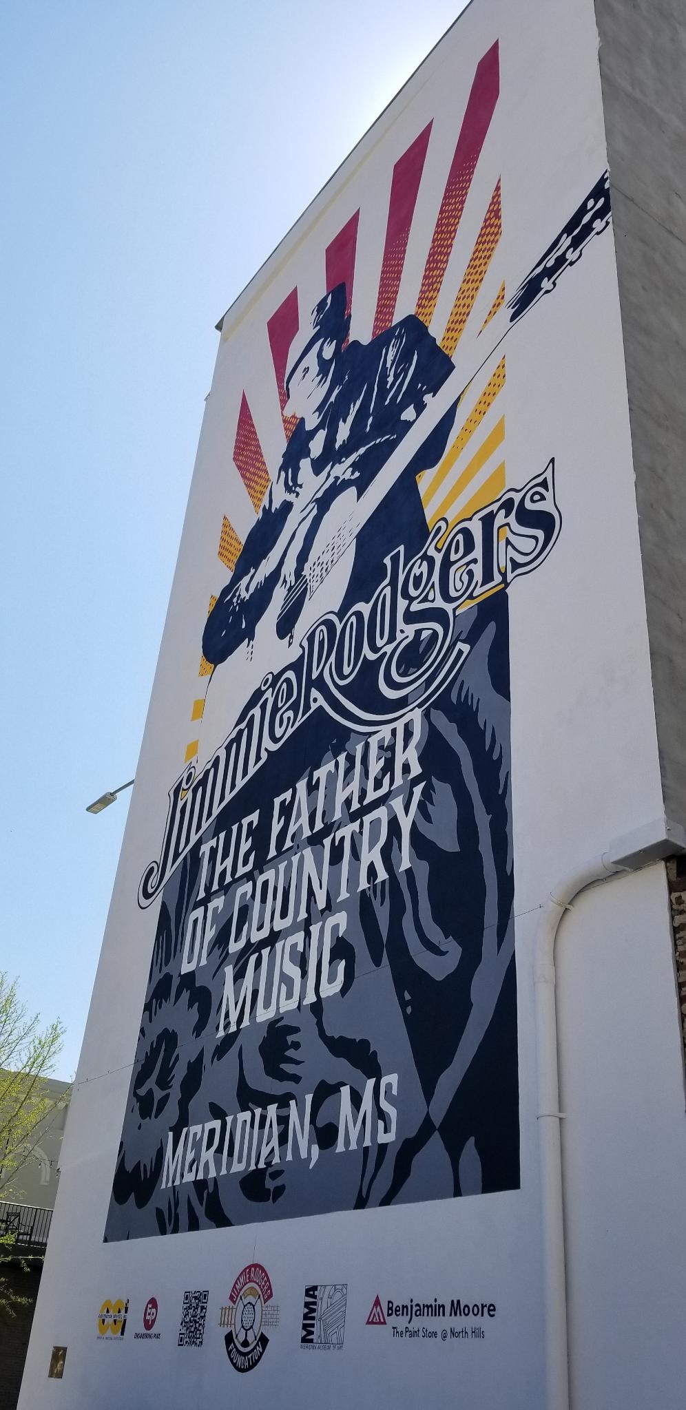 A mural portraying the musician and the words 'Jimmy Rogers, The Father of Country Music'.