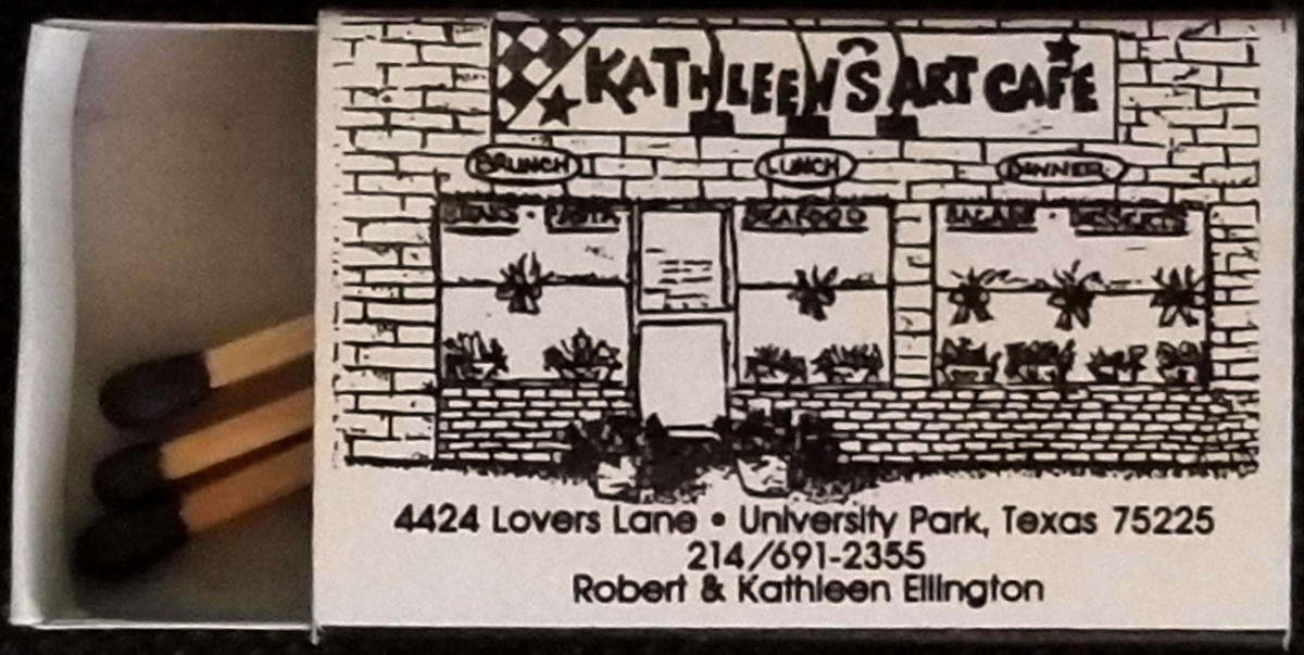 A mathbox, partially opened, in which three matches are visible, on the surface of which is an artistic representation of Kathleen's Art Cafe in Dallas.
