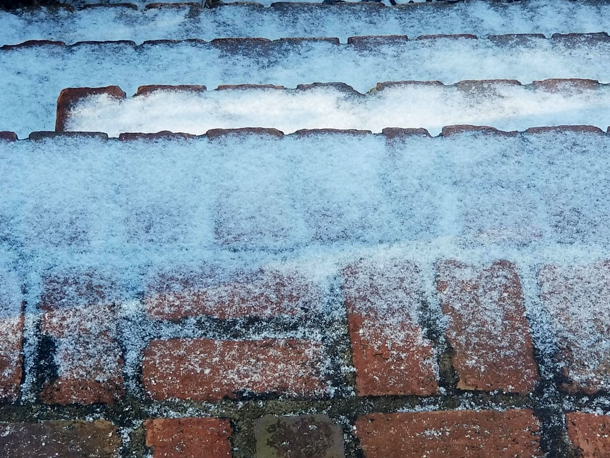 Snow, ice, and sleet on brick steps.