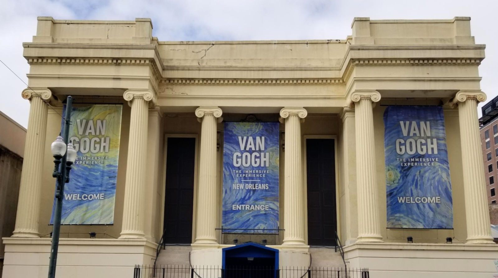 Gallery built in a classical style display banners promoting an exhition of the work of Van Gogh.