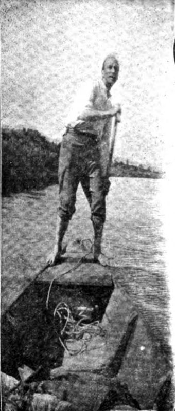 Blackwood stands on the rear of a small boat, steering, as it navigates the Danube.