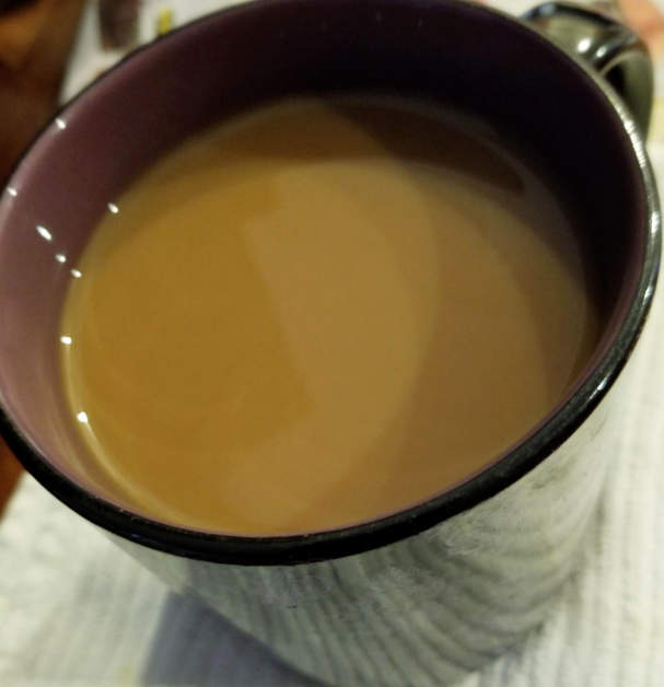 Coffee with milk in a cup.