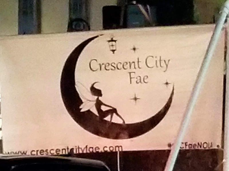Parade banner, a fairy in a crescent moon, 'Crecent City Fae', www.crescentcityfae.com.