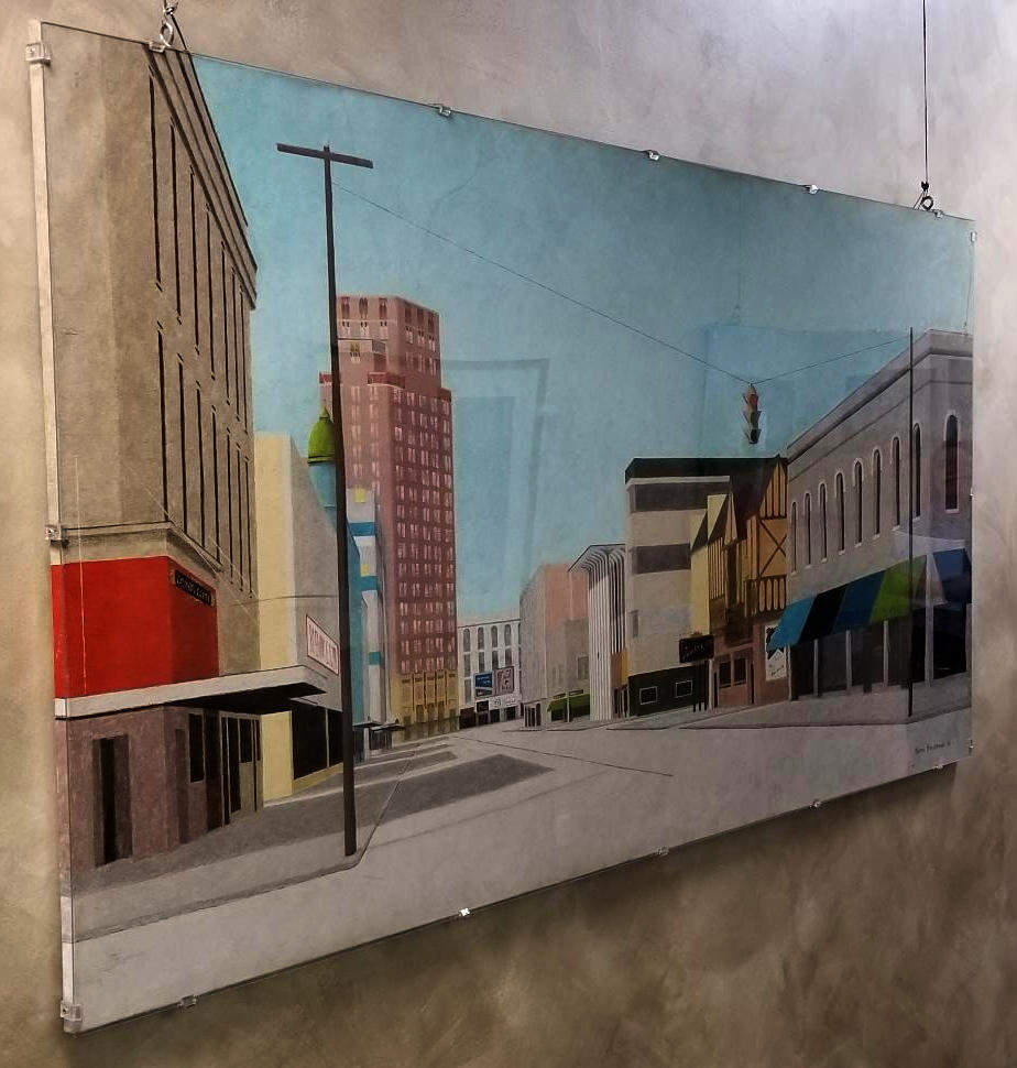 A painting on a wall that shows a city street.