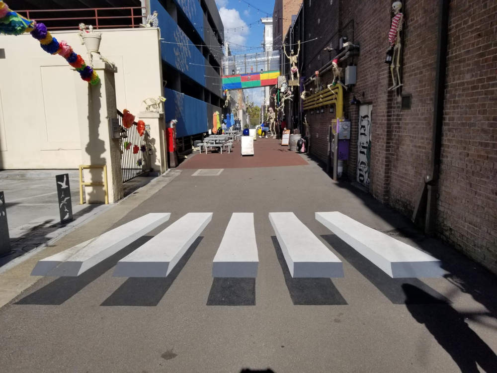 Painting, five white planks that seem to float above the street and cast a shadow.