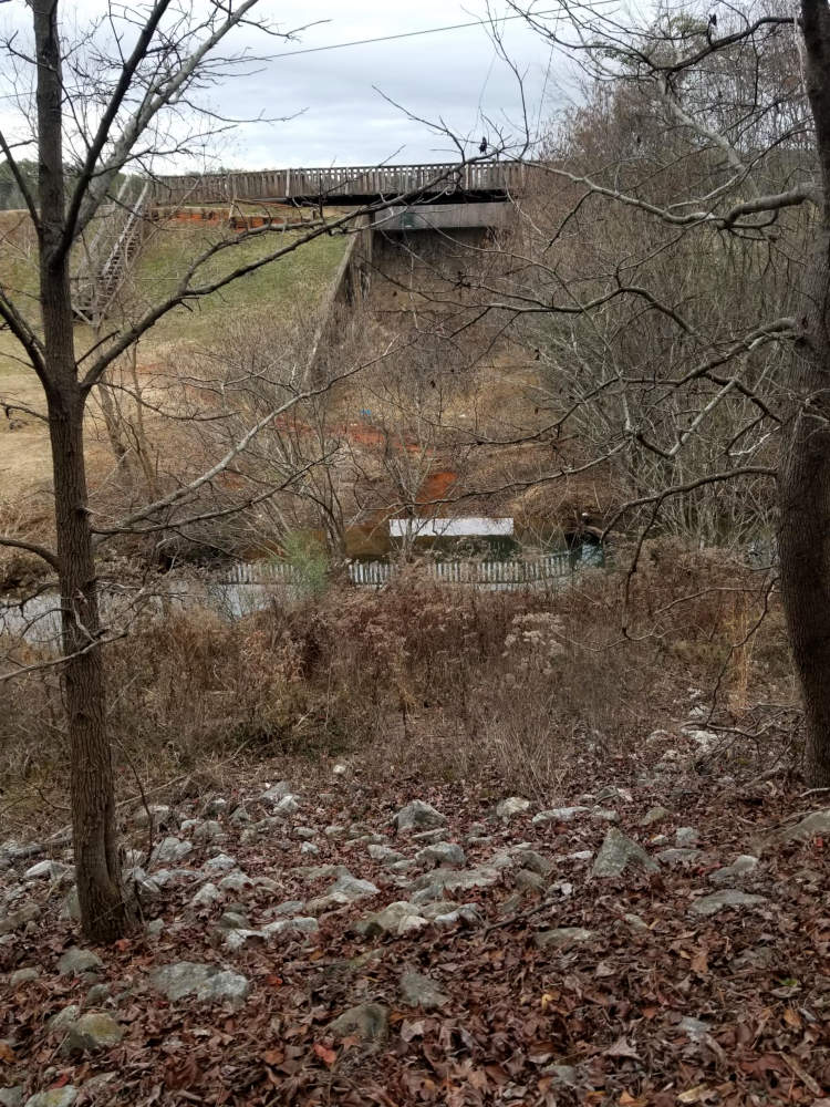 Lake spillway over which passes a foot-path.