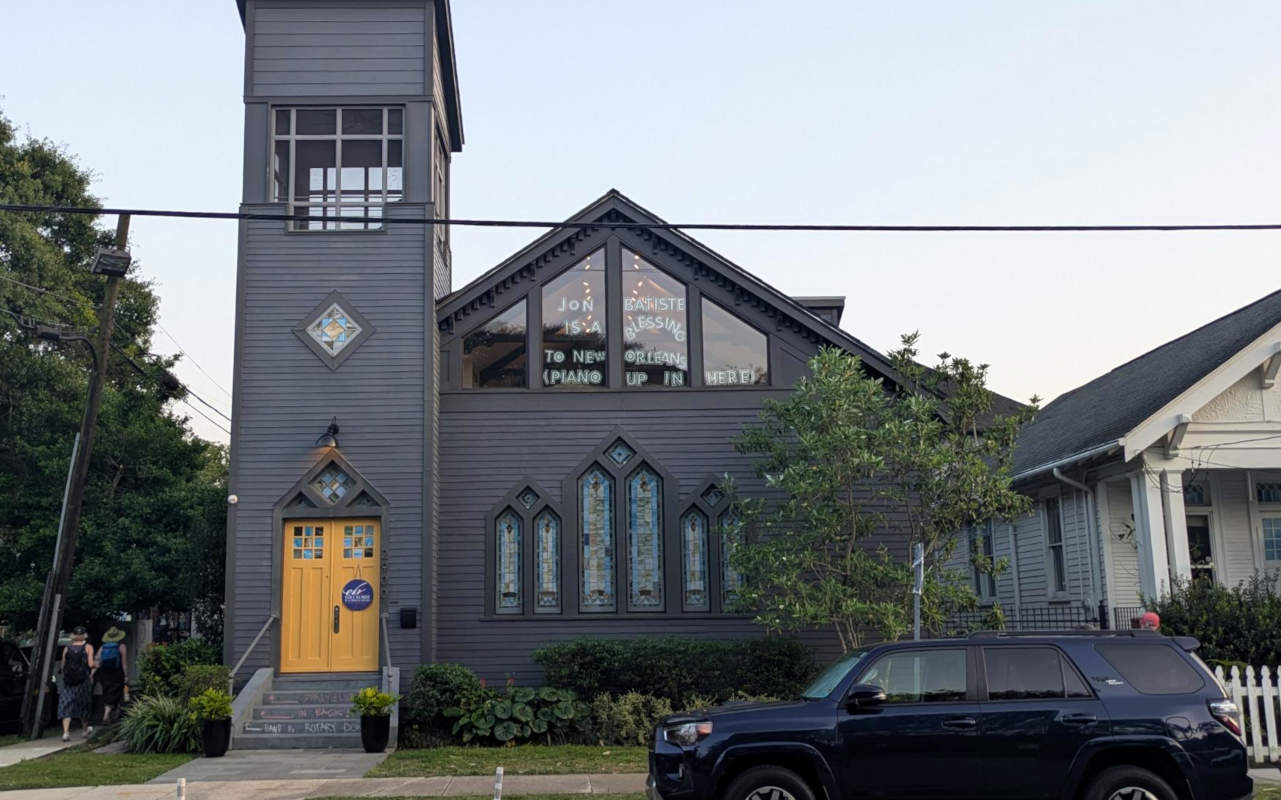 Message in church window: Jon Batiste is a blessing to New Orleans (Piano up in here)