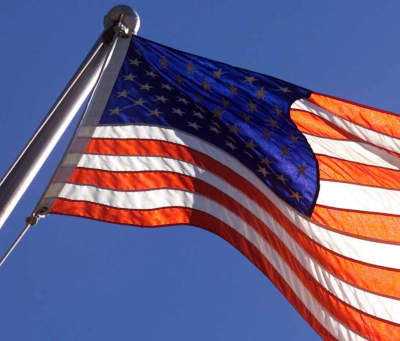 The US flag flying from a pole at the DMZ between North Korea and South Korea.