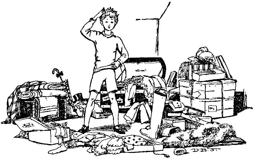 A boy scratches his head surrounded by clothes and boxes on the floor.