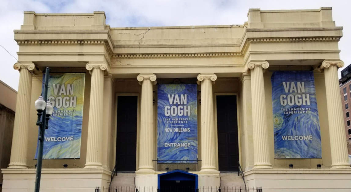 Classical style gallery, banners advertising an exhibition of Van Gogh's works.