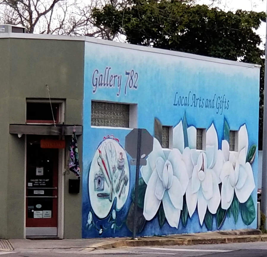 Mural, painting materials and three large magnolia flowers.