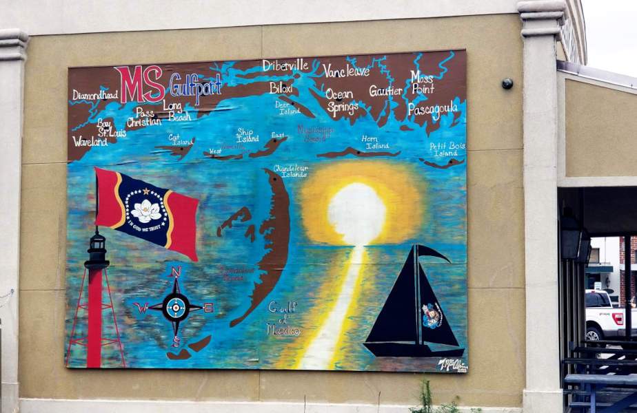 Mural, Coast, Gulf of Mexico, sunset, sailing boat, lighthouse, state flag, signature Tricia McAlvain (2021), on the Chandeleur Island Brewing Company, Gulfport Mississippi.